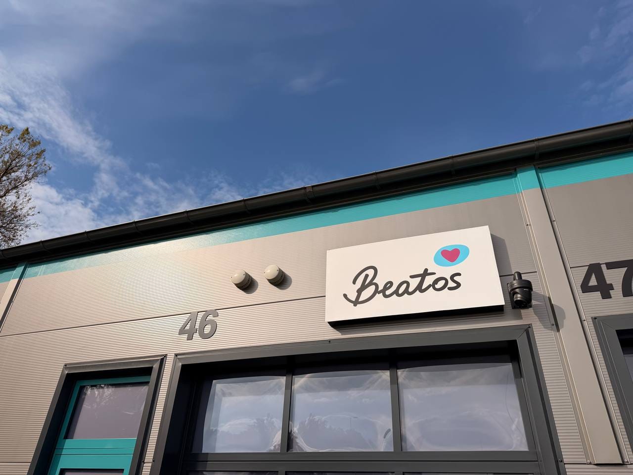 Beatos sandėlio patalpa su Beatos iškaba virš durų